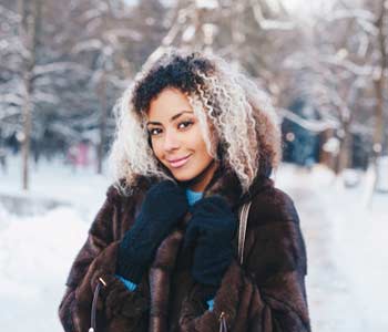 Happy young woman walking in winter time